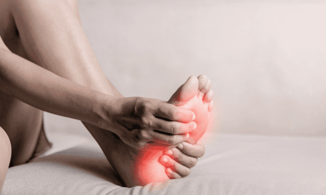 2634357 Foot pain with red inflammation, focus on sports medicine and pain management.