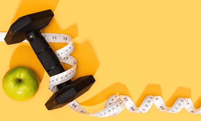 2636496 Modern exercise equipment with a green apple and measuring tape on yellow background for performance pain and sports medicine seo content.