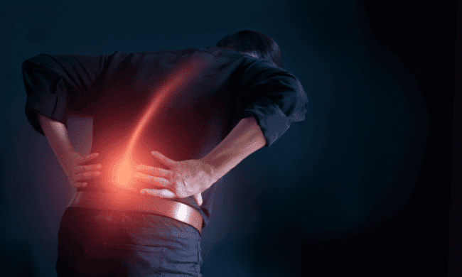 2637723 Lower back pain injury caused by muscle strain in man holding lower back, digital glow.