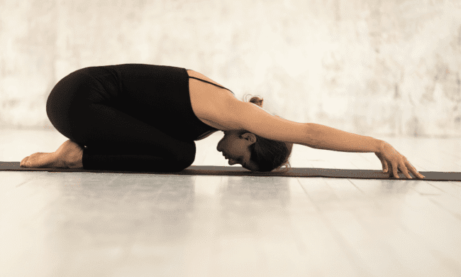 2638206 Child's Pose yoga stretch for flexibility and relaxation at Performance Pain and Sports Medicine clinic.