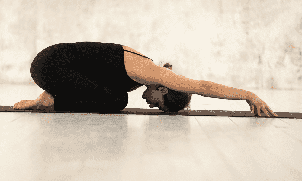 Child's Pose yoga stretch for flexibility and relaxation at Performance Pain and Sports Medicine clinic.