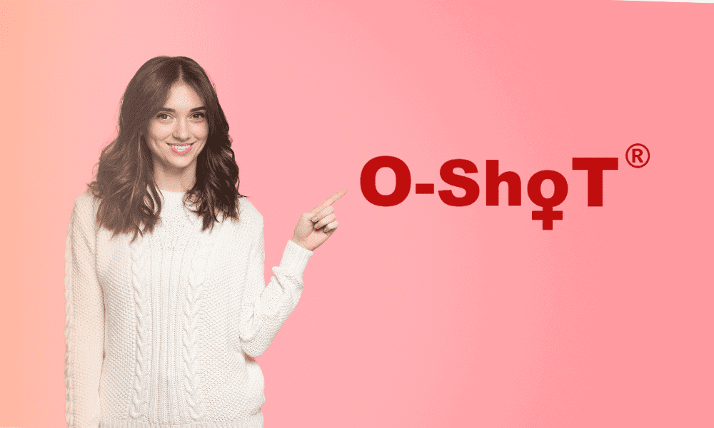 Woman smiling pointing at O-shoT logo on pink background for performance pain and sports medicine centers.