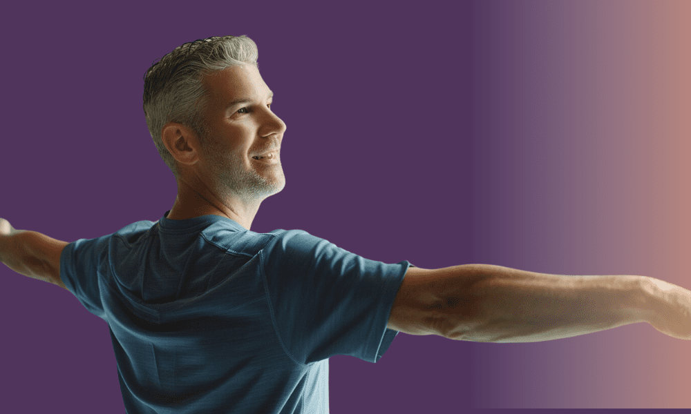Calm senior man stretching arms in a fitness clinic, emphasizing sports medicine pain relief and physical therapy.