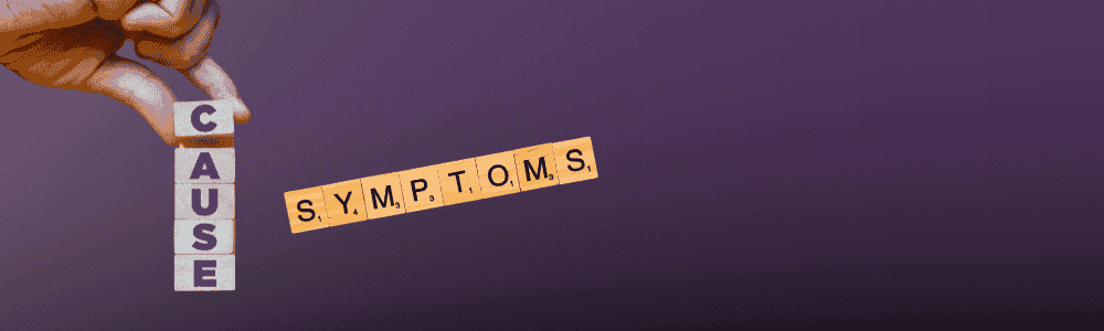 Cause of symptoms crossword being assembled by hand with letter tiles.