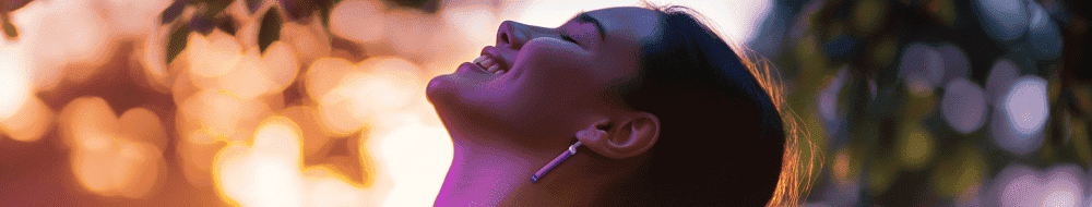 Sunset woman smiling outdoors, demonstrating relief from sports injury or pain, promoting performance pain and sports medicine services at Performance Pain and Sports Medicine clinic.