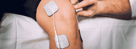 Knee injury treatment with electrical stimulation therapy at performance pain sports medicine.